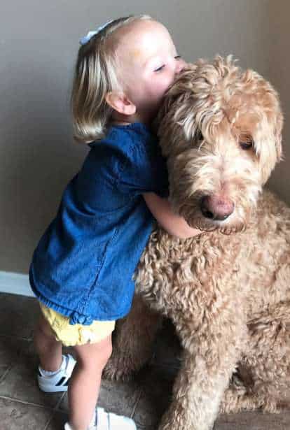 child and her dog love